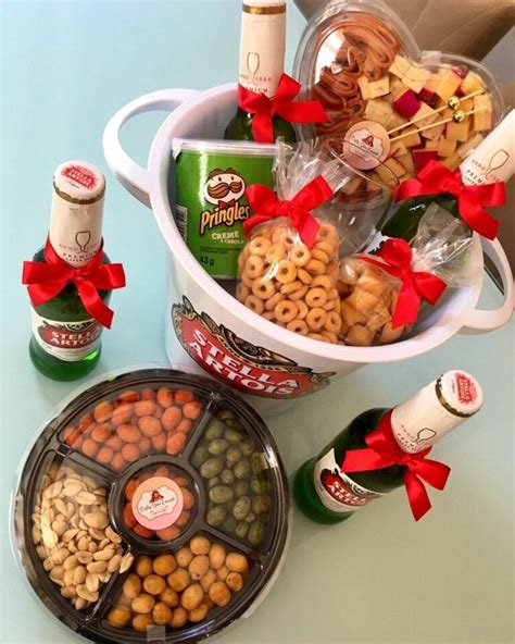 A Bucket Filled With Lots Of Different Types Of Snacks And Wine Bottles