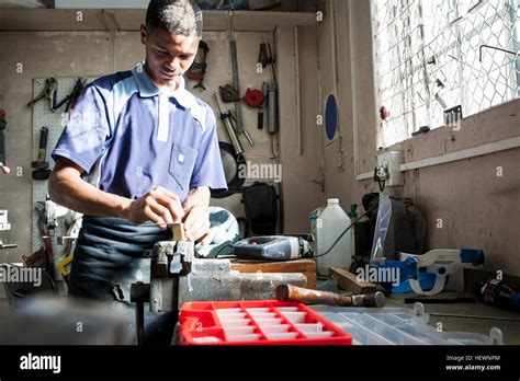 Young Man Working At Vice In Repair Workshop Stock Photo Alamy