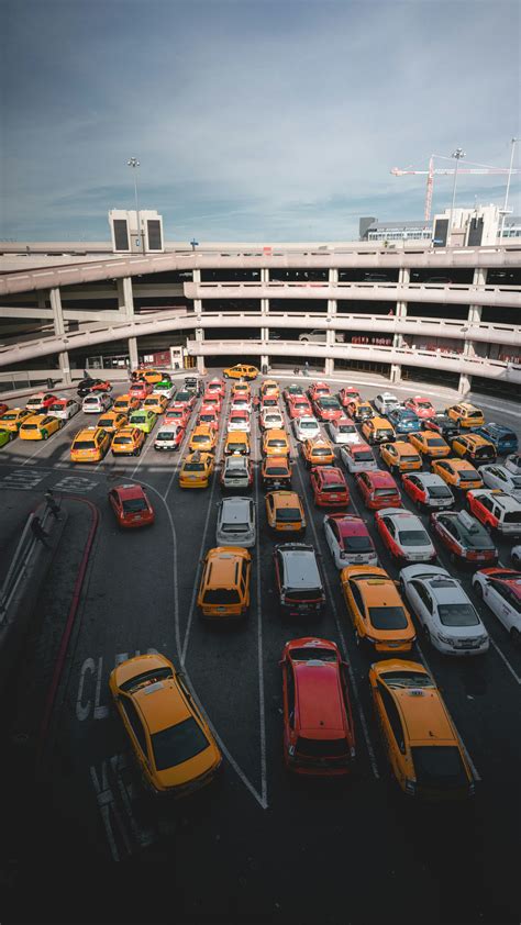 Different cars parking near white buildings photo – Free Cab Image on