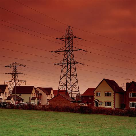 Power Cables And Pylons Over Homes Photograph By Damien Lovegrove