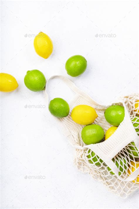 Organic Lemons And Limes In Reusable Eco Friendly String Mesh Bag Stock