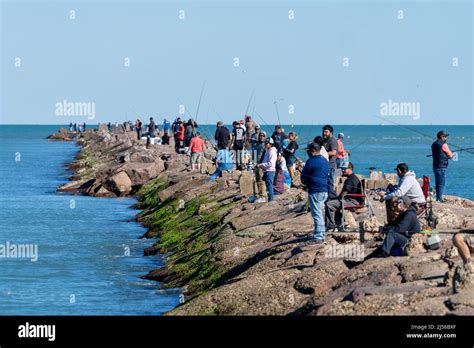 Saltwater Fishermen On The Jetty Of The Brazos Santiago Pass Ship