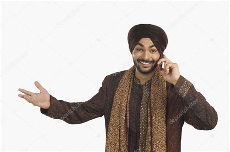 Sikh Man Talking On A Mobile Phone Stock Photo Imagedb Seller