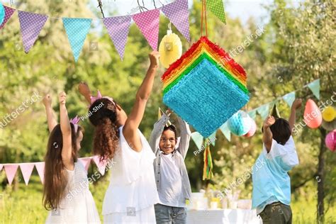 Cute children at pinata birthday party People Images | Creative Market