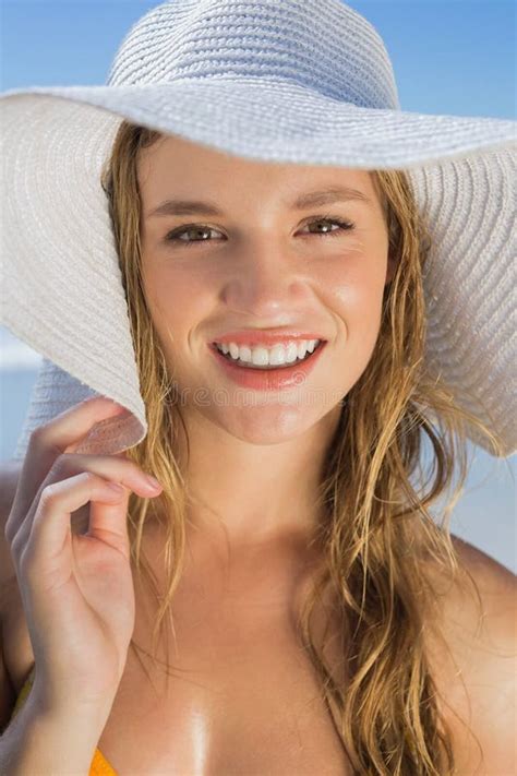 Beautiful Girl In Bikini And Straw Hat On The Beach Smiling At Camera