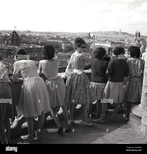 1950s Historical Group Of Young Women In Dresses Look Over The