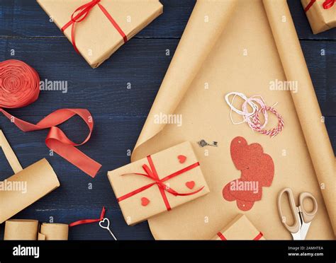 Brown Kraft Paper Packed Gift Bags And Tied With A Red Ribbon Red