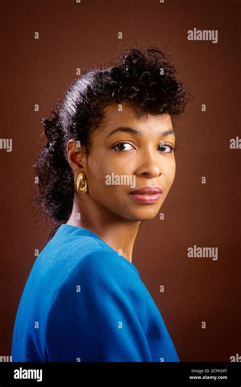 S Portrait Of African American Woman Wearing Blue Top Gold Earring