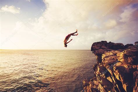 Cliff Jumping Extreme At Sunset Stock Photo By ©epicstockmedia 91480166