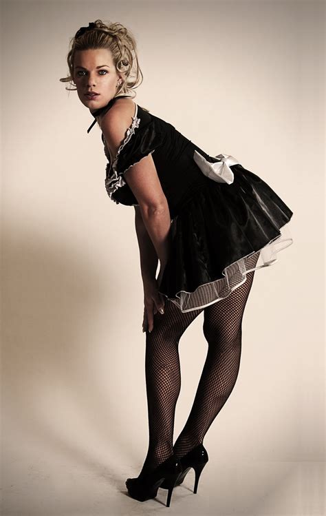 Blonde French Maid Wearing Black Fishnet Pantyhose And Black High Heels