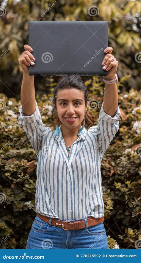 Brunette Young Women Holding Over Her Head A Laptop With Copy Space For