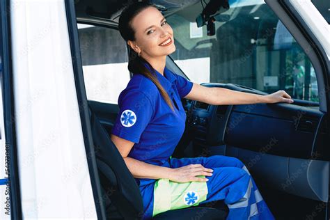 Emergency medical services worker. Portrait of female paramedic sitting inside ambulance Stock ...