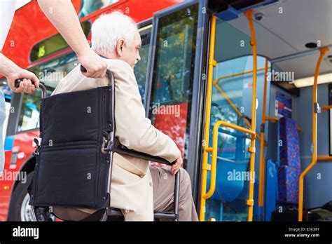 Senior Couple Boarding Bus Using Wheelchair Access Ramp Stock Photo Alamy