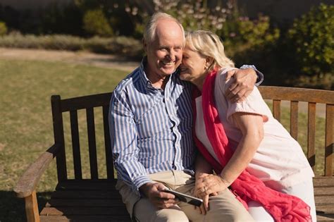 Premium Photo Senior Couple Embracing Each Other In The Park