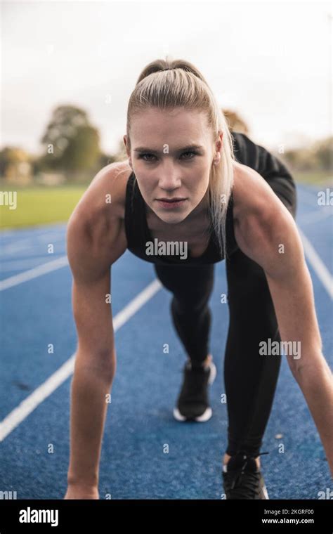 Confident Athlete At Starting Line Of Running Track Stock Photo Alamy