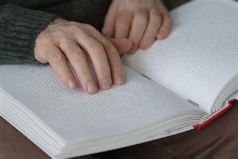 A Blind Person Reading a Braille Book · Free Stock Photo