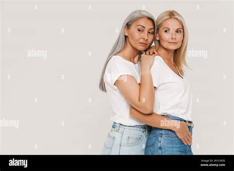 Mature Multiracial Women With Gray Hair Wearing T Shirts Posing At Camera Isolated Over White