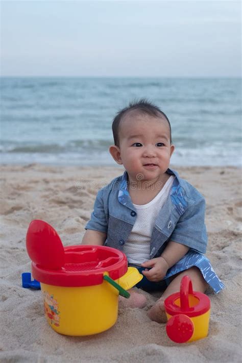 Adorable Cute Asian Baby Boy Playing With Beach Toys On Tropical Beach