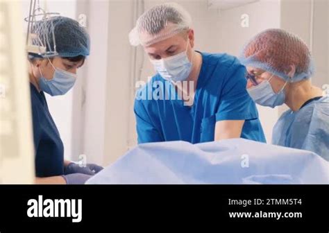 Doctor and assistant of the venous vascular surgery clinic during leg ...