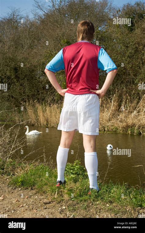 Man On Riverbank Looking At Soccer Ball In River Stock Photo Alamy