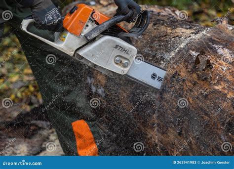 A Stihl Chain Saw Used To Cut Through A Tree Trunk Lying On The Ground Stihl Is A German