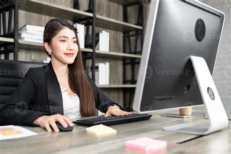 Portrait Of Pretty Business Woman Using Computer At Workplace In An