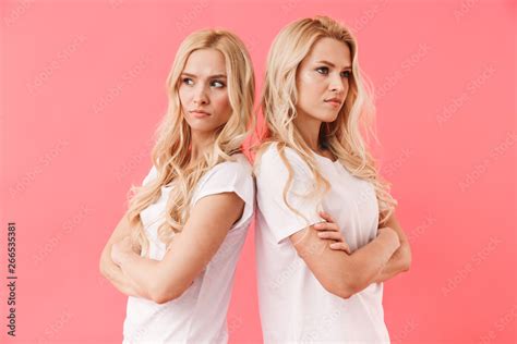 Mystery Blonde Twins Wearing In T Shirts Standing Back To Back Stock Photo Adobe Stock