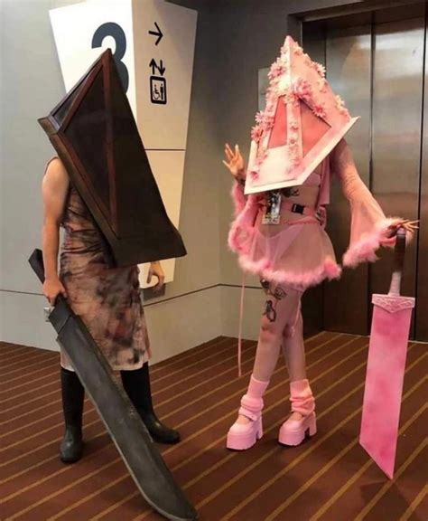 Two People Dressed Up In Costumes And Holding Umbrellas One Is Wearing