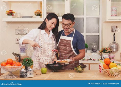 Happy Asia Couple Cooking Healthy Food in Their Loft Kitchen at Home ...