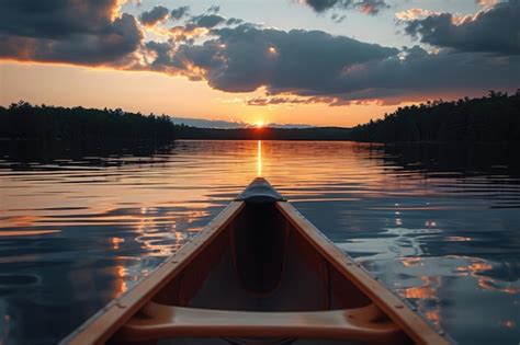 Premium Photo Bow Of A Canoe On A Lake At Sunset