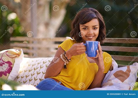 Just Me And A Cuppa Tea A Young Woman Relaxing With A Beverage In The