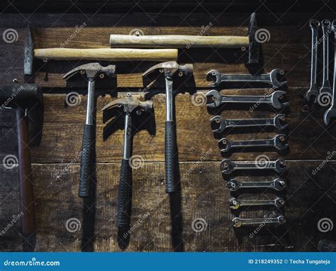 Set Of Wrench And Old Hammers Hanging On Wooden Wall Background Stock