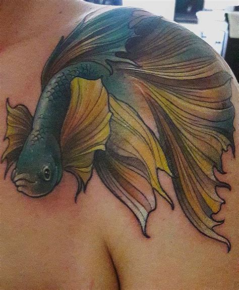 A Man With A Tattoo On His Chest Has A Goldfish In It S Back