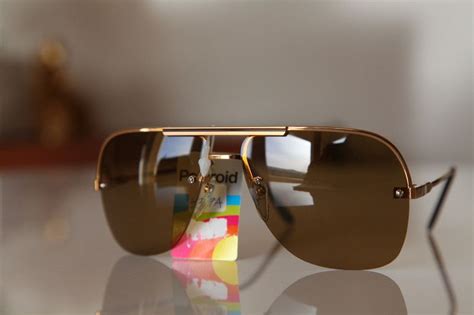 Gold Rimless Aviator Frame With A Black Stripe On Forehead And With Golden Brown Lenses From