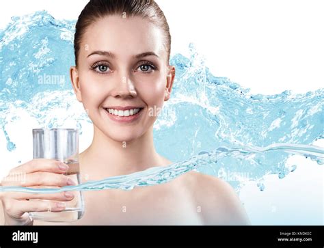 Young Woman Holds Glass With Clean Water In Splashes Of Water Stock