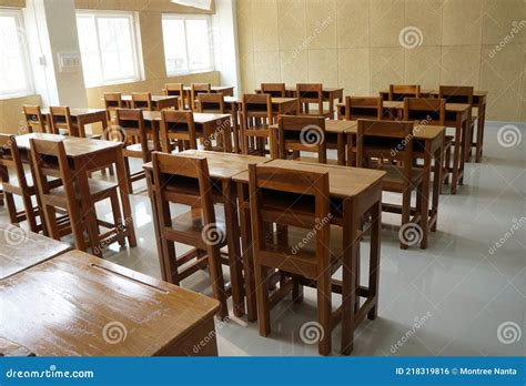 Student Desks And Chairs Are Arranged Neatly In The Classroom Stock