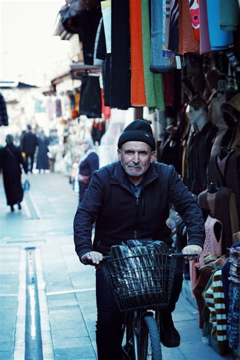 Old Man Riding Bicycle On Market · Free Stock Photo