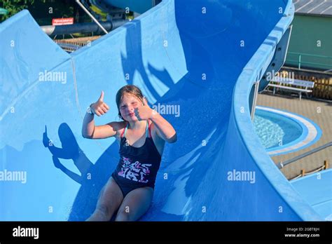 Girl Sliding Down On A Water Slide In Aqua Park Vacation Concept