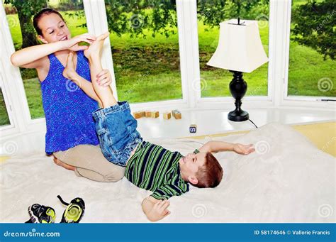 Child Lifting Foot To Girl To Tickle Stock Photo - Image of barefeet, barefoot: 58174646