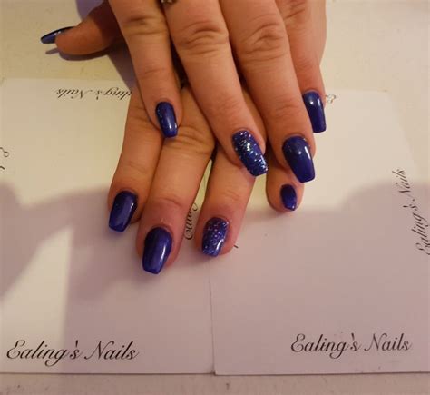 Acrylic Extensions With Blue Gel Polish And Glitter Feature Nail