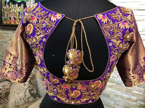 The Back Of A Blouse With Gold And Purple Designs On It Sitting On A