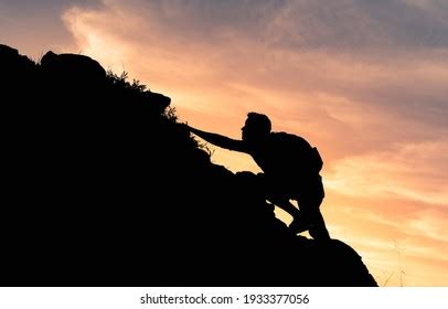 Silhouette Man Climbing Steep Edge Mountain Stock Photo 1933377056