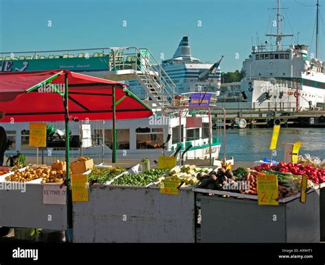 Market Stall With Vegetable In Background Ships On Harbor Port In