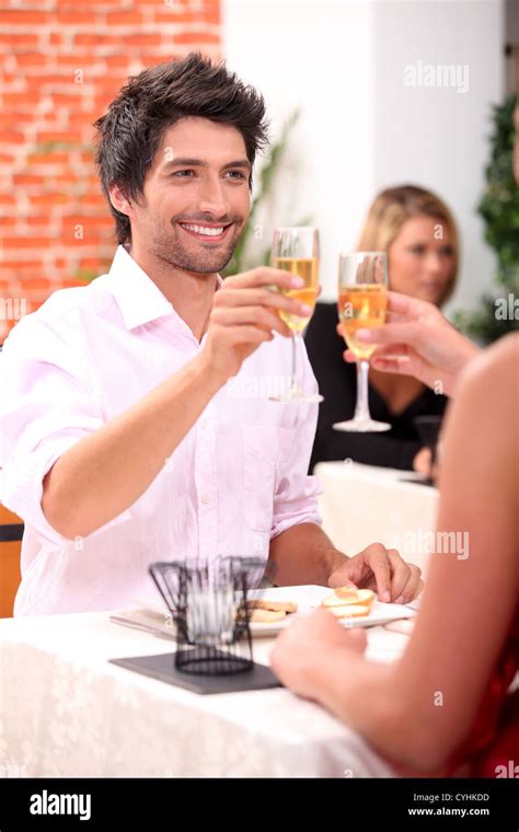 Couple Celebrating In Restaurant Stock Photo Alamy