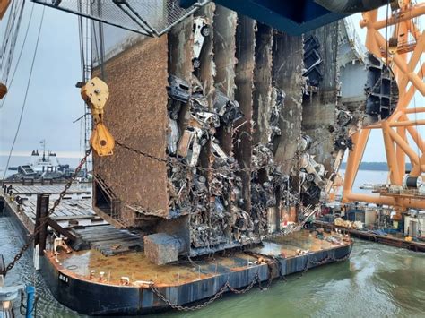 An Overturned Cargo Ship Is Sliced With A Very Powerful Chain The