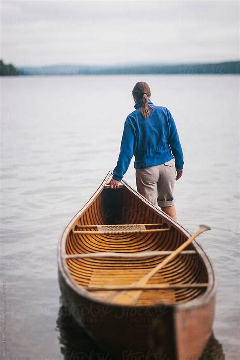 Woman With Wooden Canoe On Lake In Maine By Stocksy Contributor