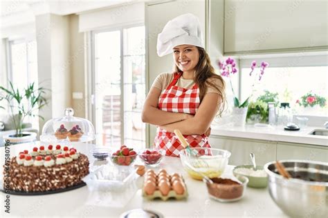 Beautiful Young Brunette Pastry Chef Woman Cooking Pastries At The Kitchen Happy Face Smiling