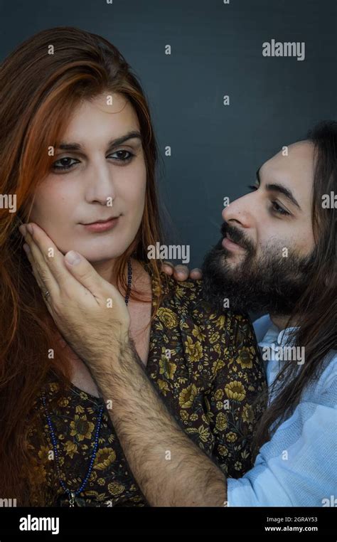 Portrait Of A Young Couple Where The Young Man With Beard And Long Hair