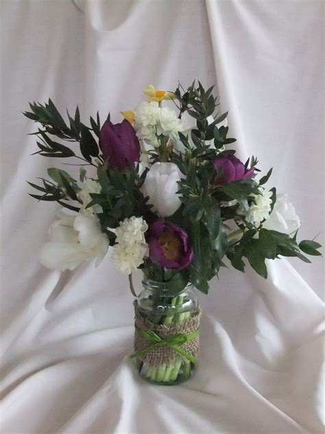 Jam Jar Posy Of Spring Flowers For Mother S Day Decorated With Hessian