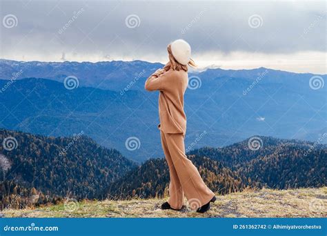 Slender Blonde Woman In Casual Beige Clothes And Beret Posing Against